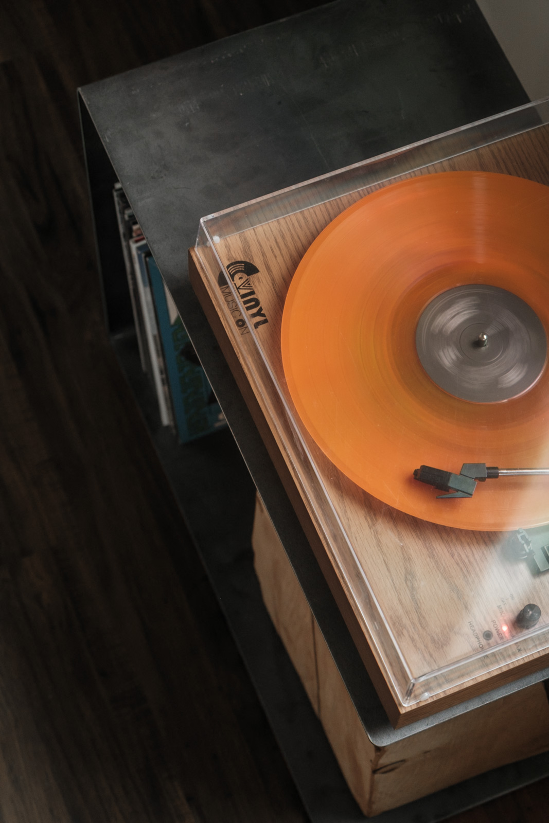 Close-up detail of BND Series hand-bent steel frame and wood record stand.